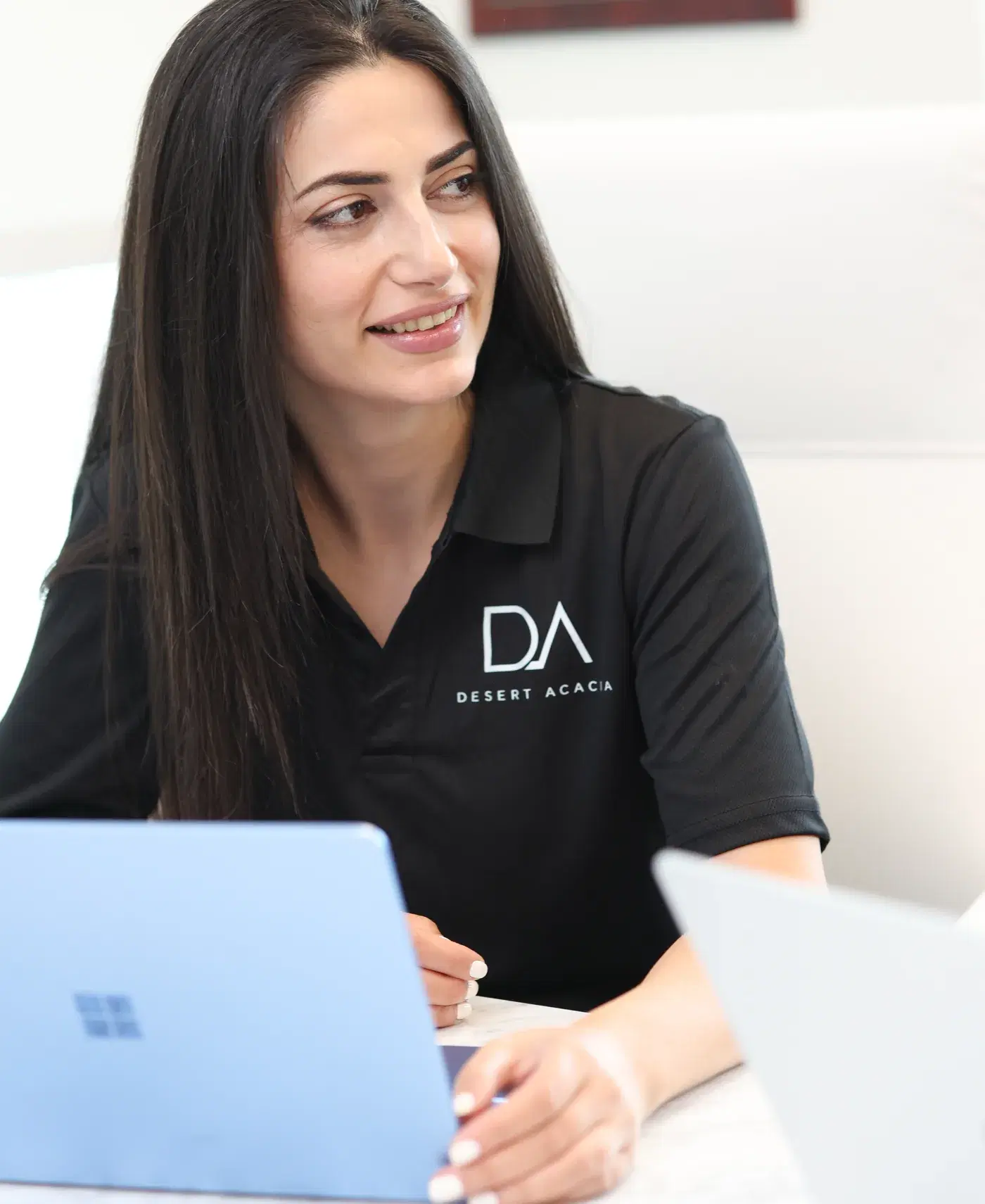 A Desert Acacia team member reviewing work